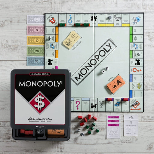 a monopoly board game sitting on top of a wooden table