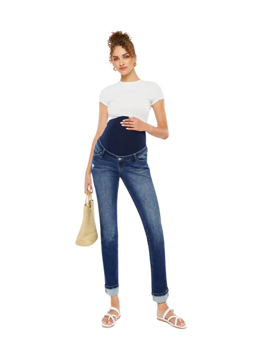a pregnant woman in a white shirt and maternity jeans