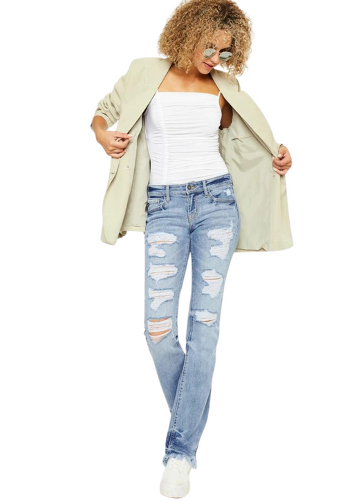 a woman in ripped jeans and a jacket