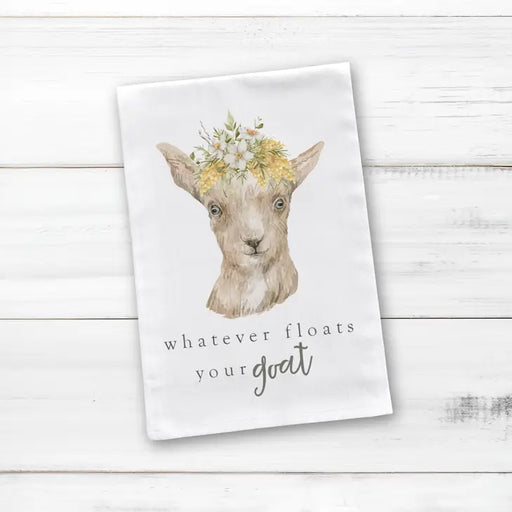 a white napkin with a goat wearing a flower crown