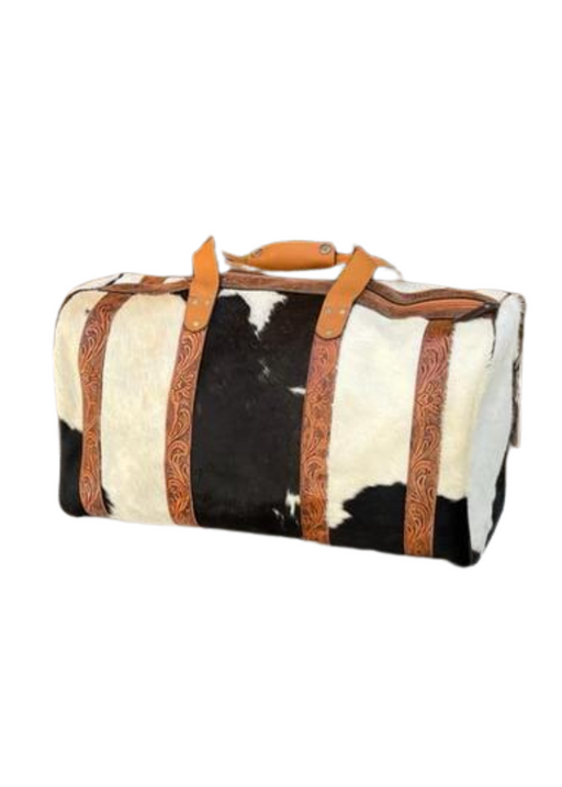 a black and white cowhide duffel bag