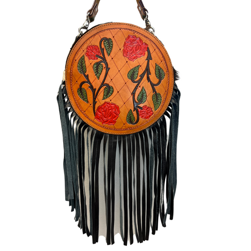 a round purse with flowers and fringes on a white background
