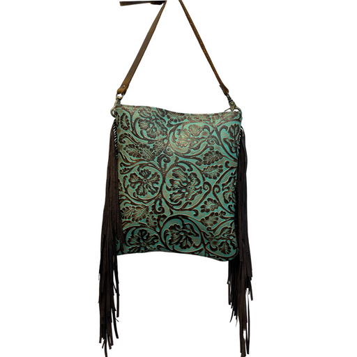 a turquoise and brown tooled leather crossbody purse with fringe hanging from it