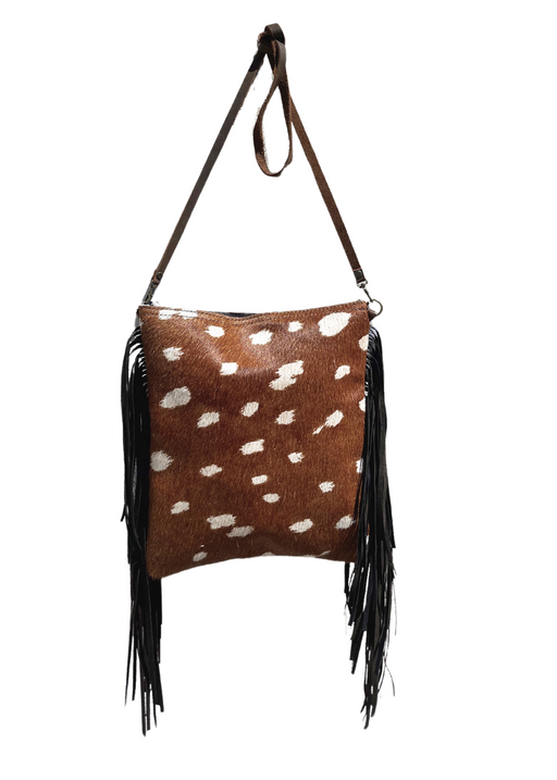 a brown and white spotted purse hanging from a hook