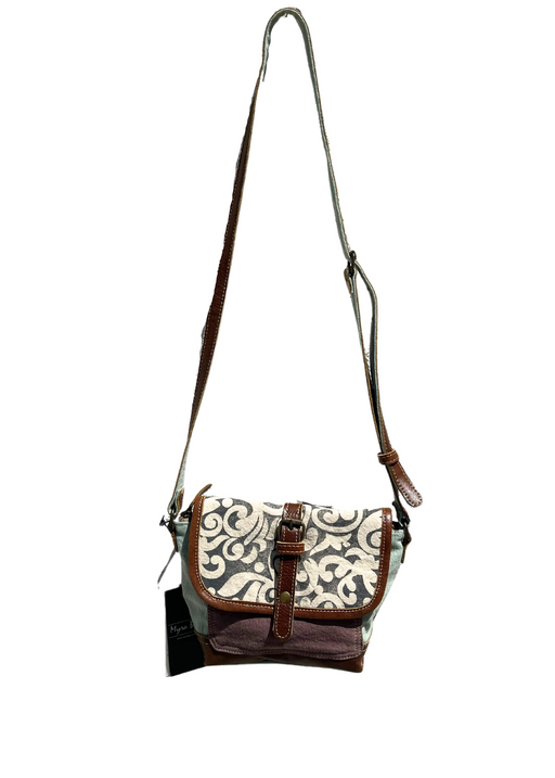 a white and brown purse with leaf print on a white background