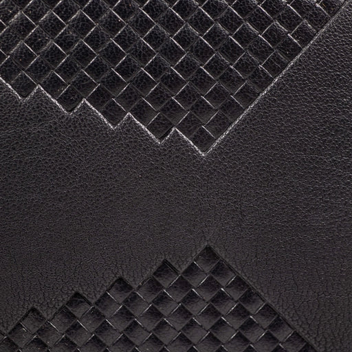 a close up of a black leather hatch weave texture