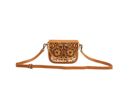 a small purse with a hand-tooled design on it