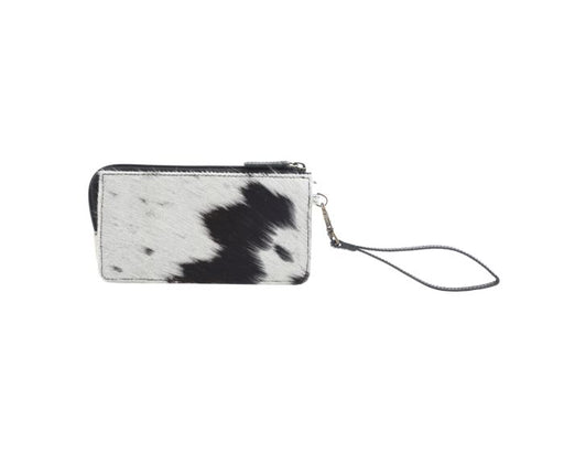 a black and white cow print wallet on a white background