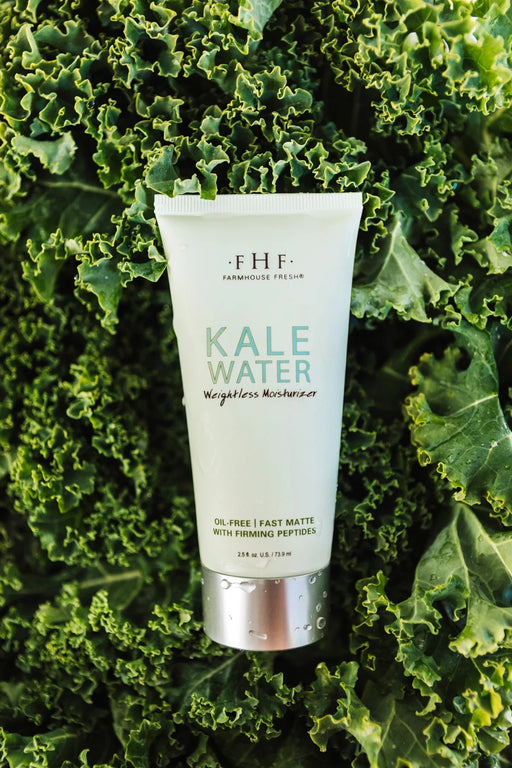 a tube of kale water moisturizer sitting on top of a green plant