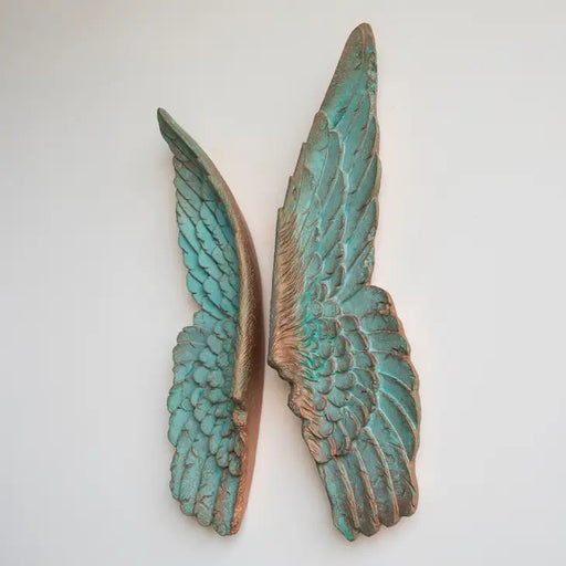 a pair of green wings on a white background