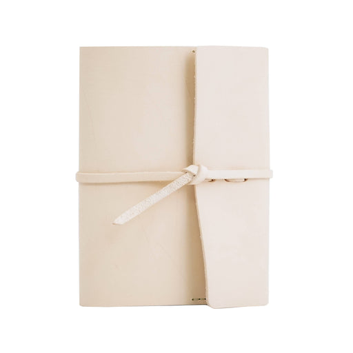 a white notebook wrapped in a white ribbon