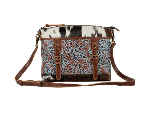 a purse with a cowhide pattern on it