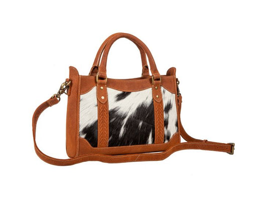 a brown and white handbag on a white background