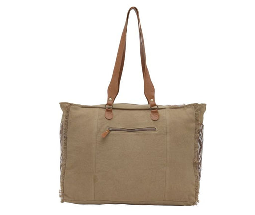 a large beige bag with a brown handle