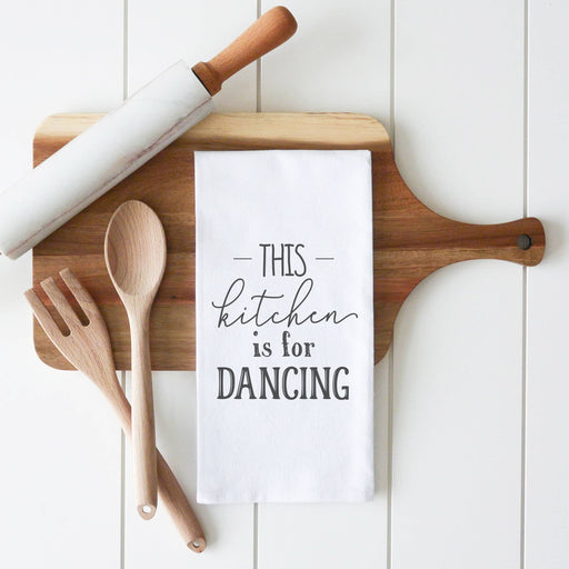 a kitchen towel that says this kitchen is for dancing
