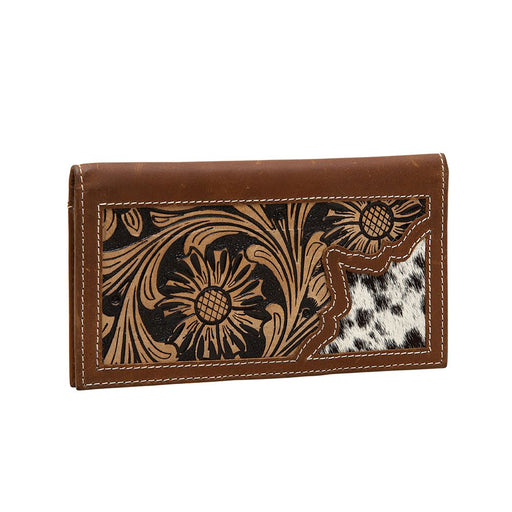 a men's wallet with a hair on hide cow print and tooled leather design on it