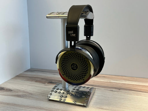 a pair of headphones sitting on top of a metal stand