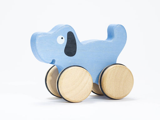a wooden toy dog with wheels on a white background