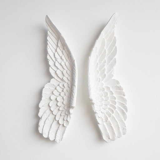 two white angel wings on a white background