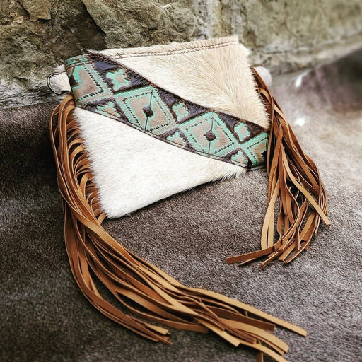 a white and brown purse with a tassel
