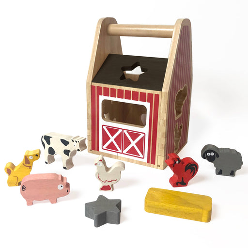 a wooden toy set with farm animals and a barn