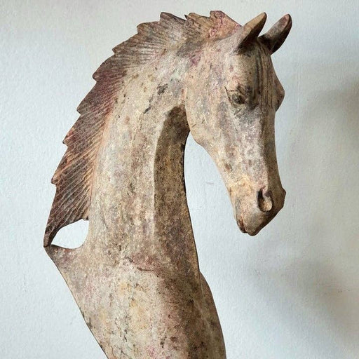 a close up of a horse head sculpture on a white background