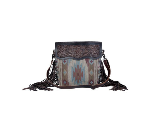 a purse with fringes and a pattern on it