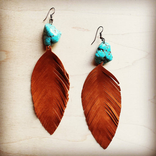 a pair of brown leather earrings with turquoise beads
