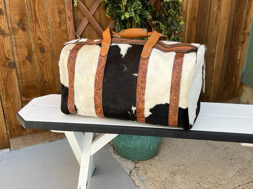 a brown and white bag sitting on top of a bench