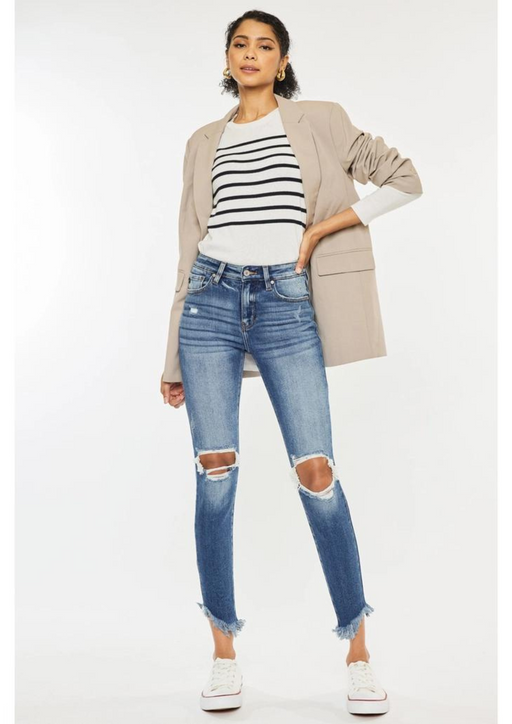 a woman wearing ripped jeans and a jacket