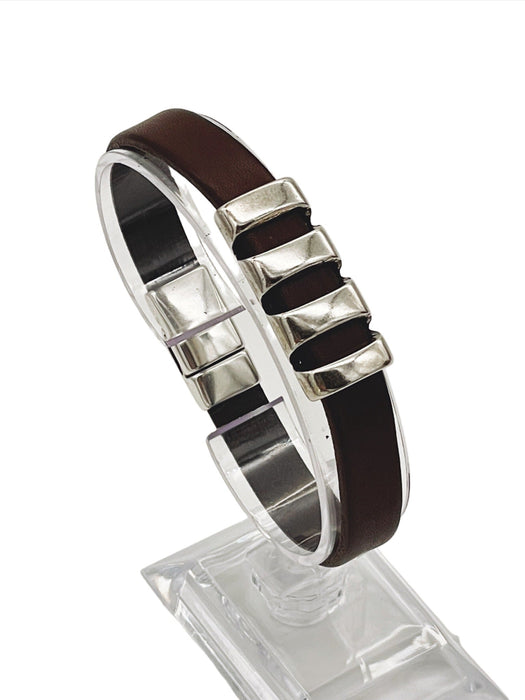 a brown leather bracelet on a clear stand