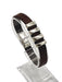 a brown leather bracelet on a clear stand