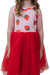 a little girl wearing a red dress with strawberries on it