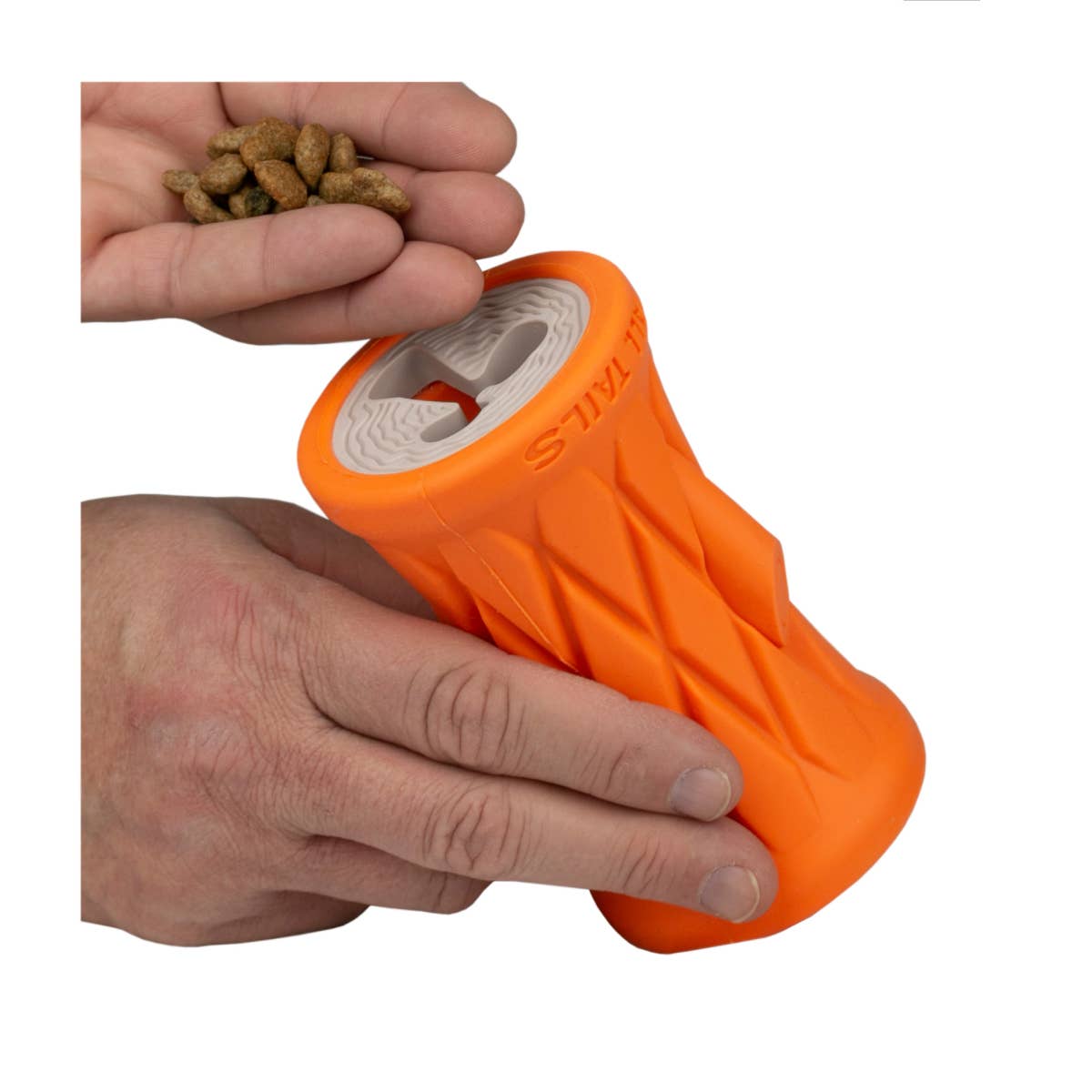 a hand holding an orange object with nuts in it