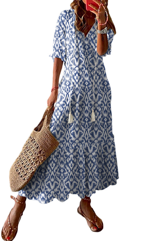 a woman in a blue and white dress holding a straw bag