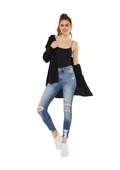 a woman wearing ripped jeans and a black top