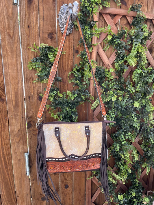 a purse hanging on a wooden fence