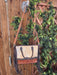 a purse hanging on a wooden fence