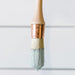 a paint brush on a white background with paint on it