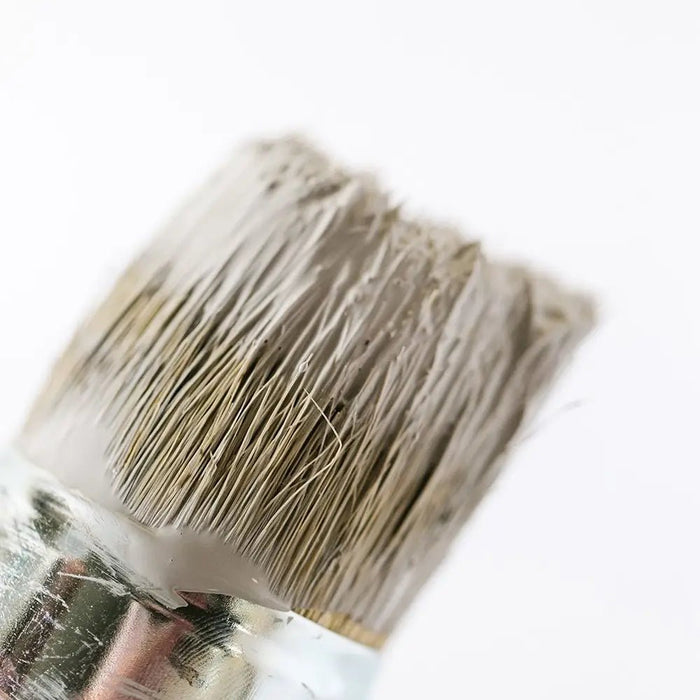 a close up of a paint brush with a white background