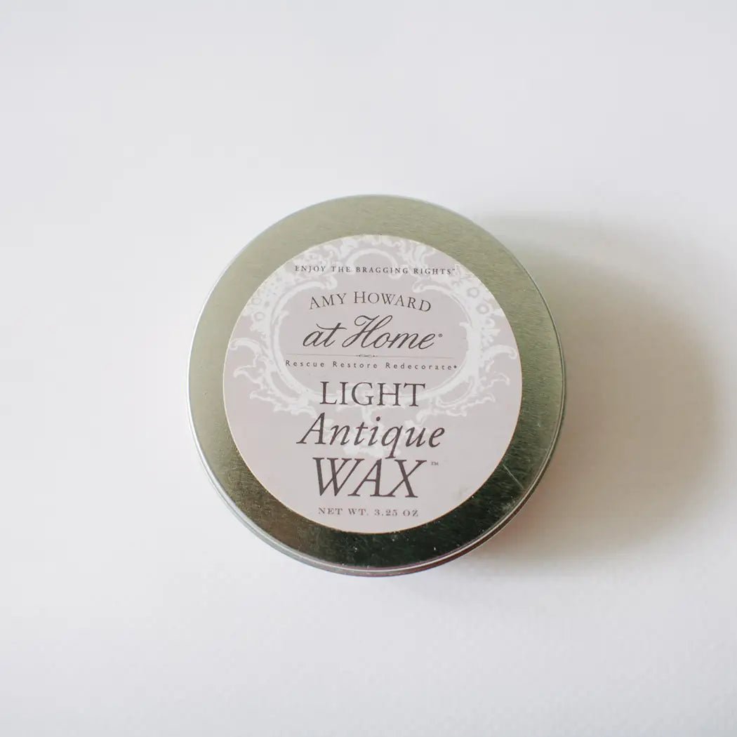 a tin of wax sitting on top of a white table