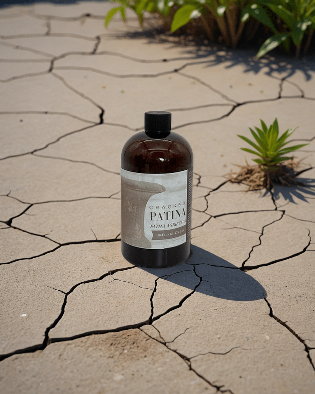 a bottle of cracked patina sitting on a cracked ground