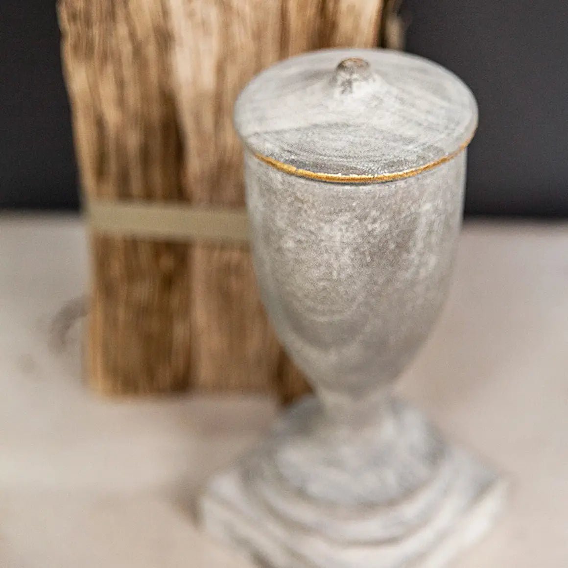 a silver corbel sitting on top of a table next to a wooden block