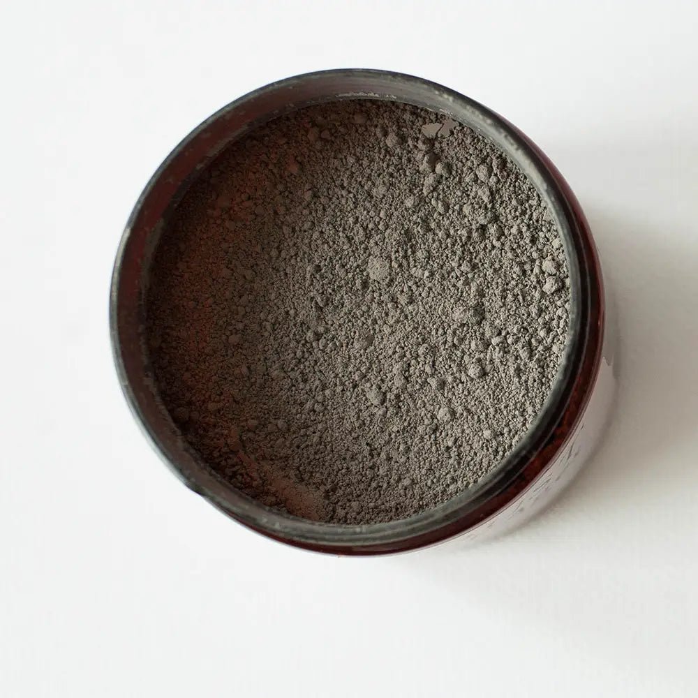 a jar of dust of ages powder on a white background