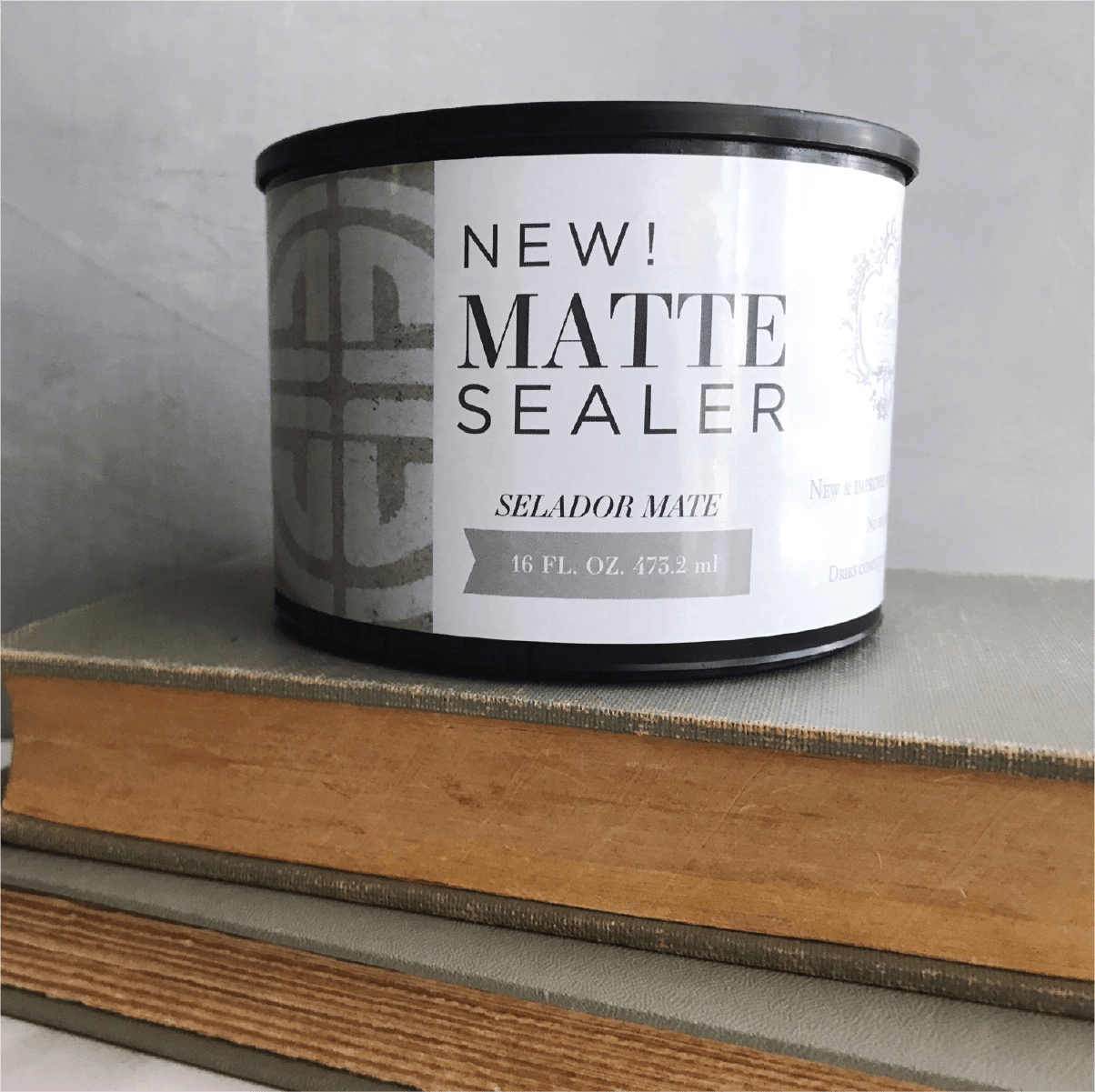 a can of new matte sealer sitting on top of a book