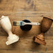 a pair of wooden shoes and a paintbrush on a wooden table