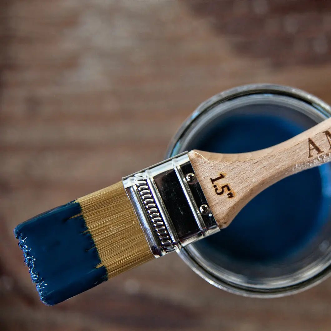 a close up of a paint brush with blue paint