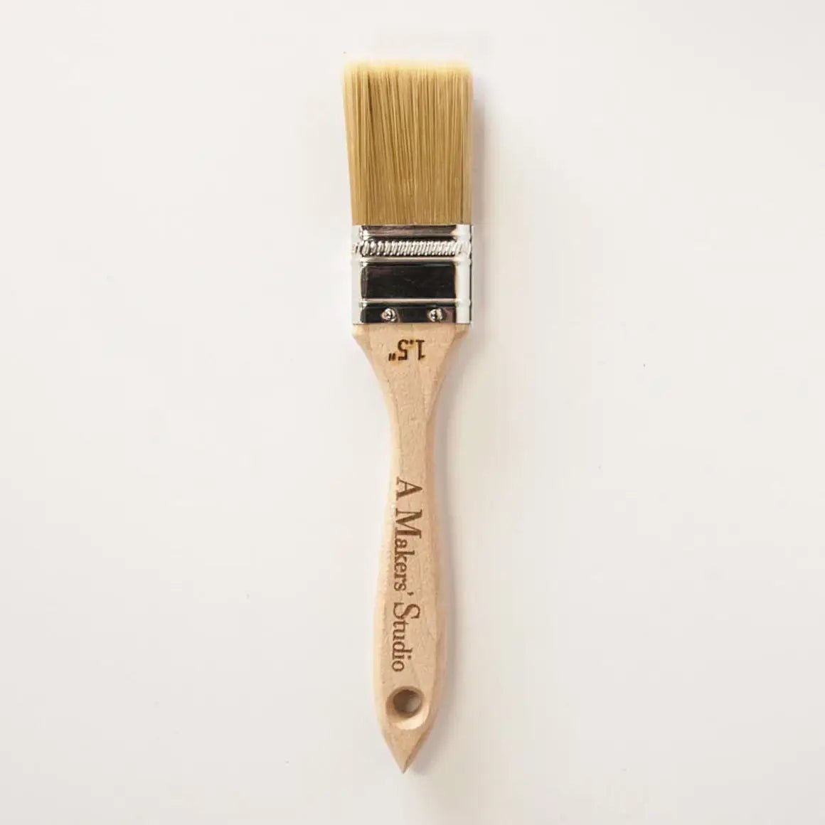 a paint brush with a wooden handle on a white background