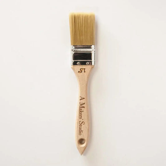 a paint brush with a wooden handle on a white background