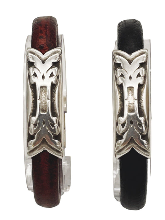 a pair of silver and leather bracelets